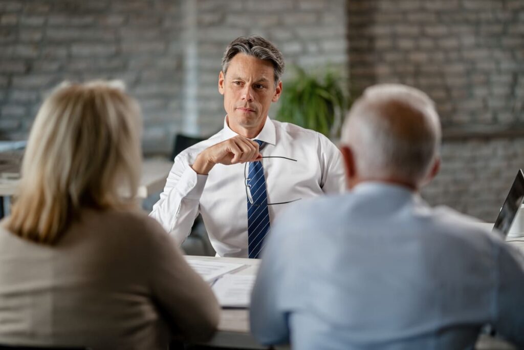 Financial advisor advising senior couple during the meeting in the office